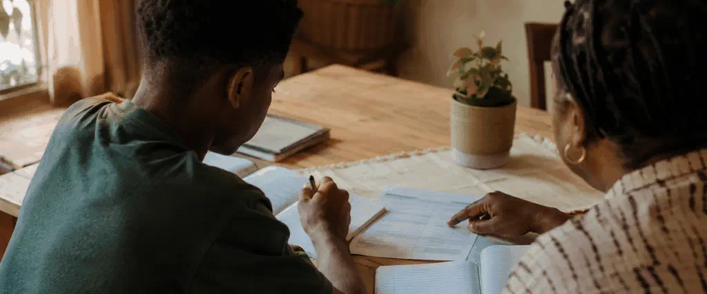 Grade 9 learner and parent discussing subject choices together at a dining table