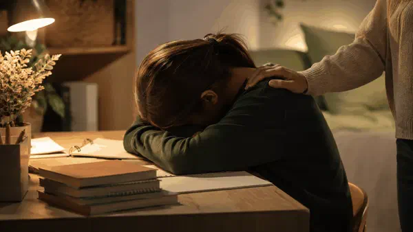 Teenage student looking calm and relieved while preparing for exams
