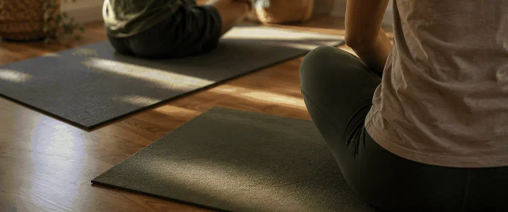 Parent and teenager doing a gentle TRE exercise in a calm room